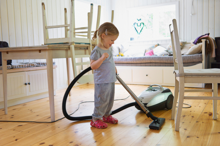 Young Girl Vacuuming Hardwood Floor, Sweden
